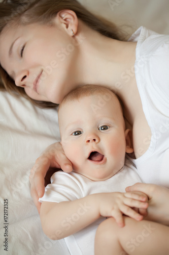 Mom and baby. Mother with daughter or son. Tenderness and embrace, happiness maternity, home comfort and warmth.