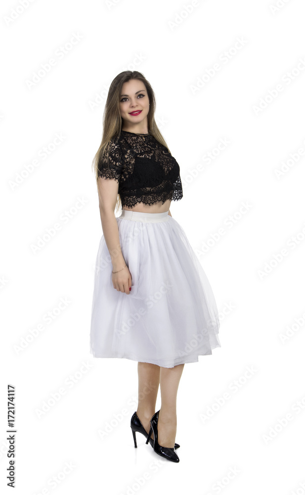 Emotional girl in white skirt posing on a white background.
