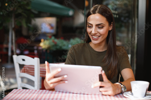 Young woman using a digital tablet in a cafe