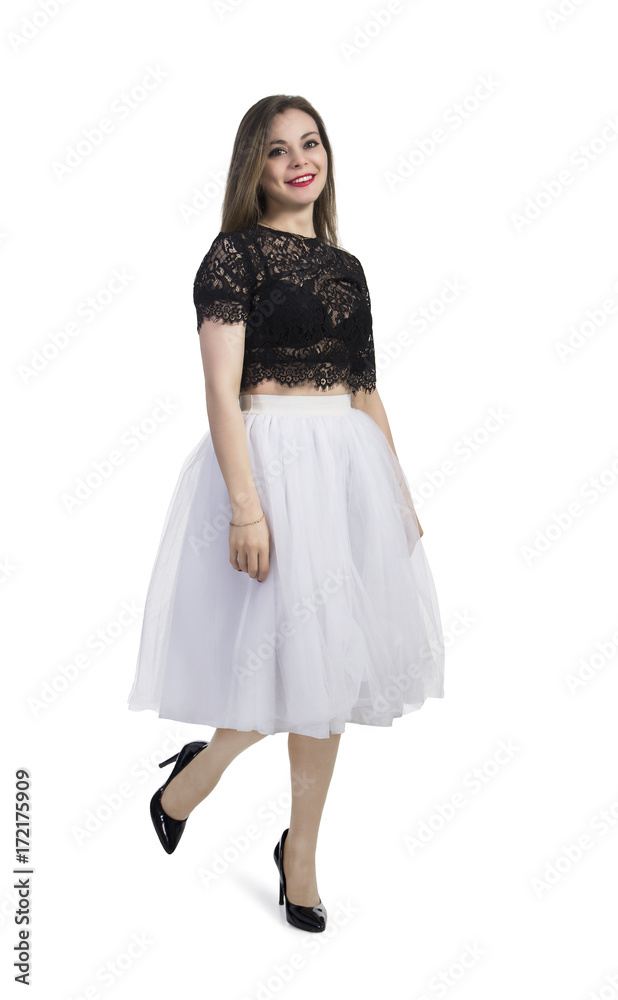 Emotional girl in white skirt posing on a white background. Emotional girl in white skirt posing on a white background.