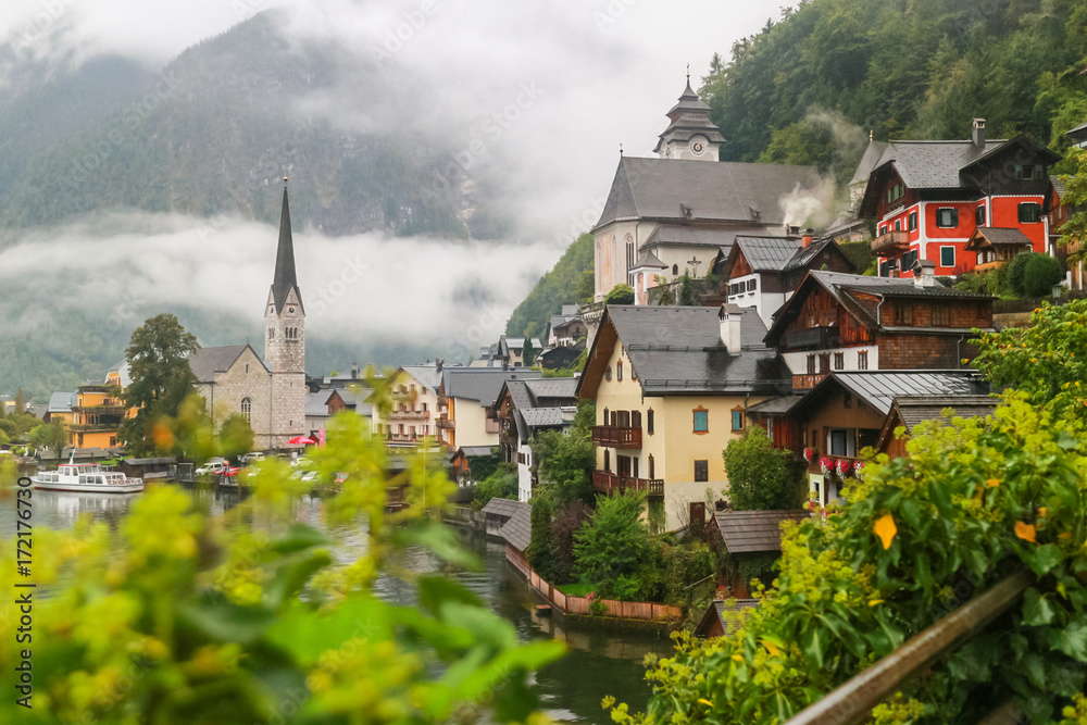 Scenic view of famous Hallstatt mountain village in the Austrian Alps with misty raining, Salzkammergut region, Austria