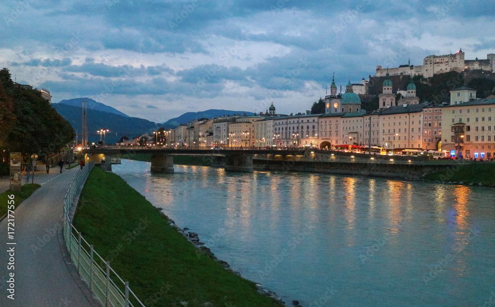 Cityscape of the Salzach river and the old city in center of Salzburg at sunset twilight, Austria