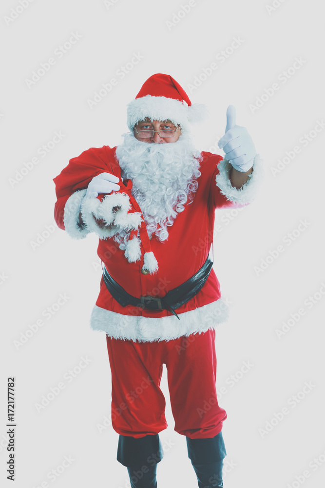 Real Santa Claus carrying big bag full of gifts, isolated on white background Real Santa Claus carrying big bag full of gifts, isolated on white background