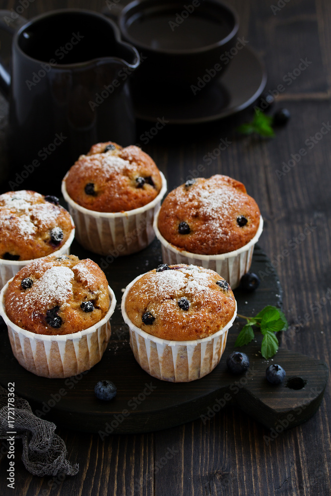 Oat muffins with blueberries on a dark background. Oat muffins with blueberries on a dark background.