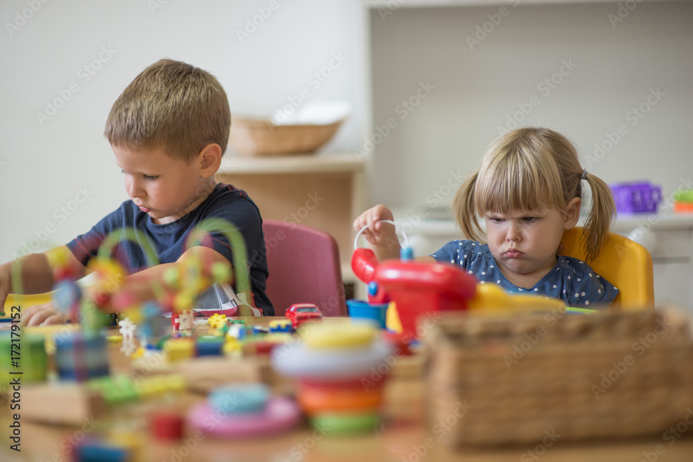 Two chidren are playing at pre school with montessori toys Two chidren are playing at pre school with montessori toys