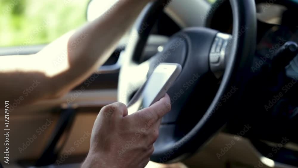 Man Uses His Smartphone While Driving, Slow Motion Closeup Man Uses His Smartphone While Driving, Slow Motion Closeup