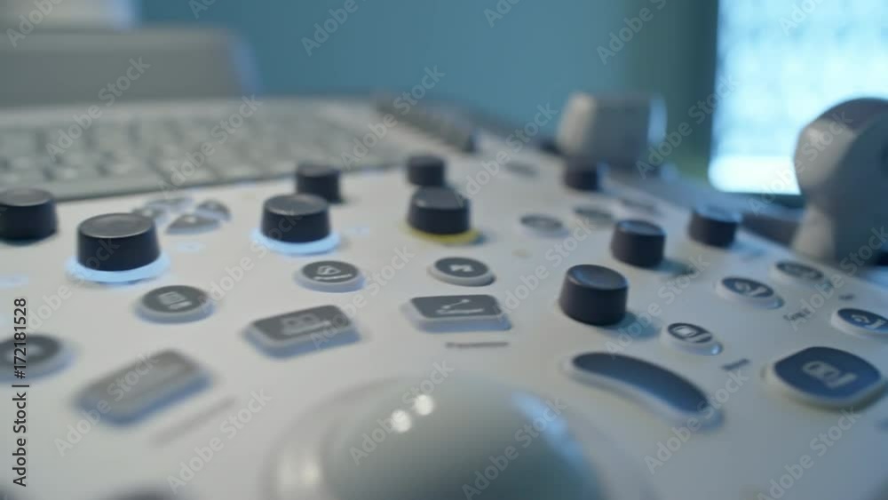PAN with close up of keyboard and transducer tube on control panel of ultrasound machine PAN with close up of keyboard and transducer tube on control panel of ultrasound machine