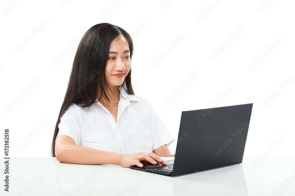 Young pretty smiling Asian woman typing on black laptop isolated Young pretty smiling Asian woman typing on black laptop isolated