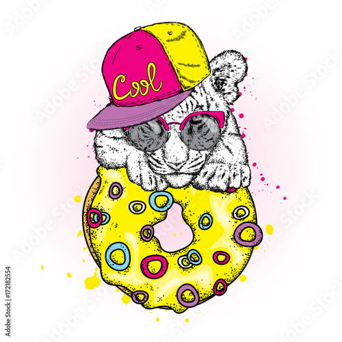 Fototapeta Naklejka Na Ścianę i Meble -  Cute tiger cub and a large multi-colored donut. Vector illustration.