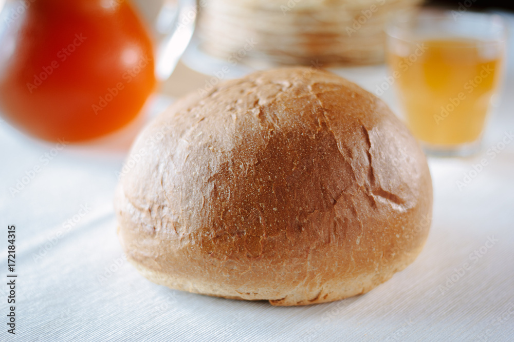 Fresh hot bread on white tablecloth at restaurant table. Fresh hot bread on white tablecloth at restaurant table.