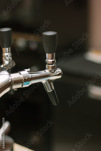 Beer faucet on bar ready to fuel a beer.