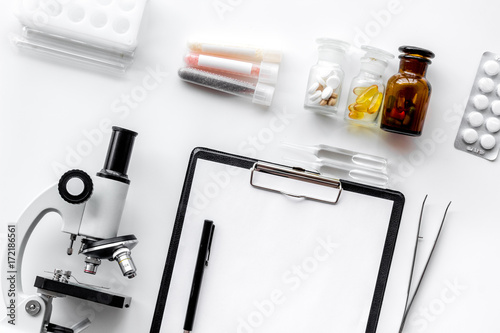 Do medcal tests. Microscope, tablet, pills and test tube on white background top view photo