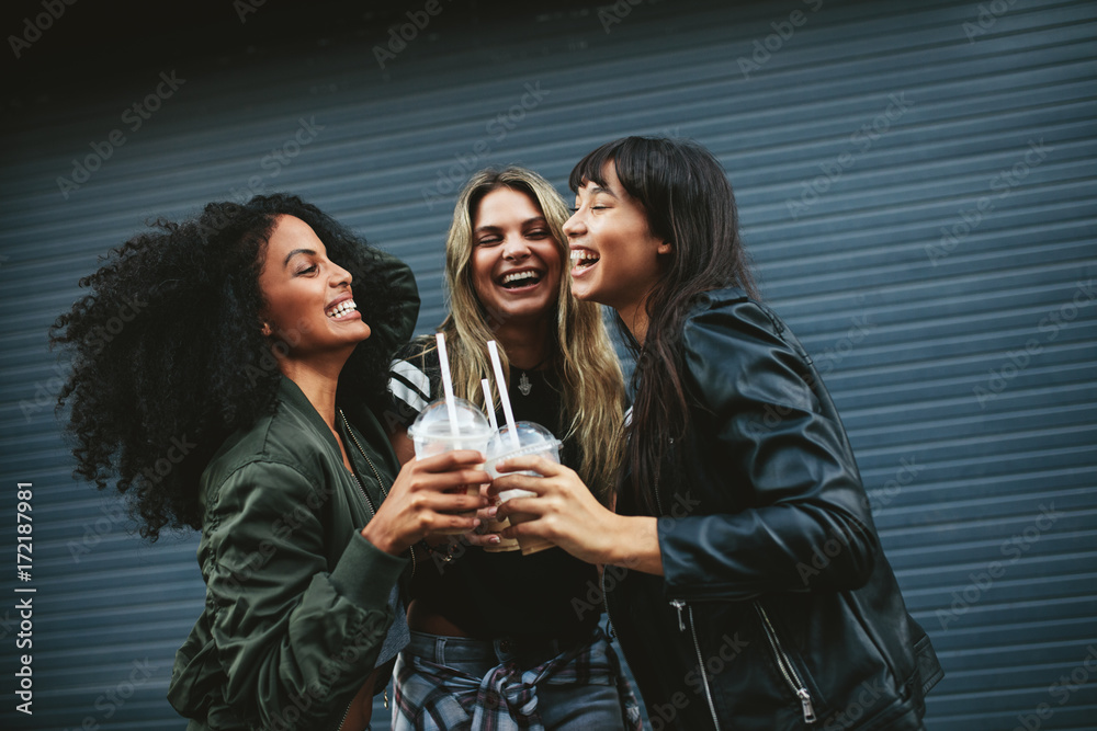 Smiling young women with ice coffee