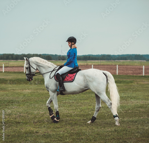 Middle-aged woman riding her horse © Nejron Photo
