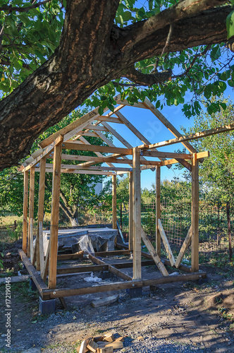 Frame of an unfinished wooden pergola for rest