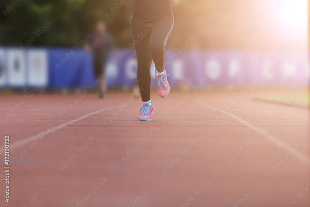 Fototapeta premium woman running jogging in stadium healthy exercise.