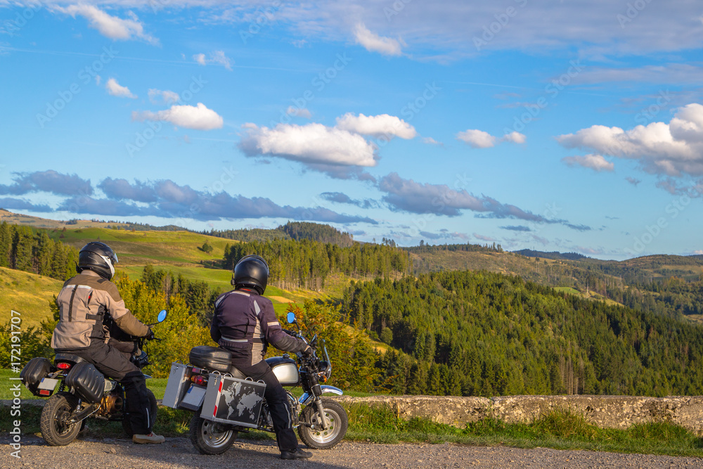 two men travel but a bike in the mountains. tourism two men travel but a bike in the mountains. tourism