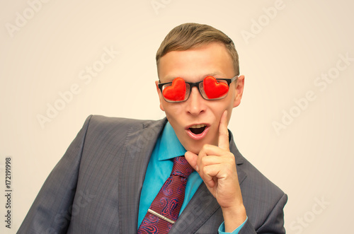 Fall in love. Womanizer man. Ladies man. Womanizer man in suit, heart shape glasses and wide open mouth looking on beautiful sexy woman. photo
