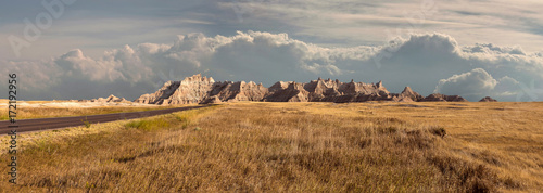 Panorama of badlands national park with vista of mountain range with large clouds in background photo
