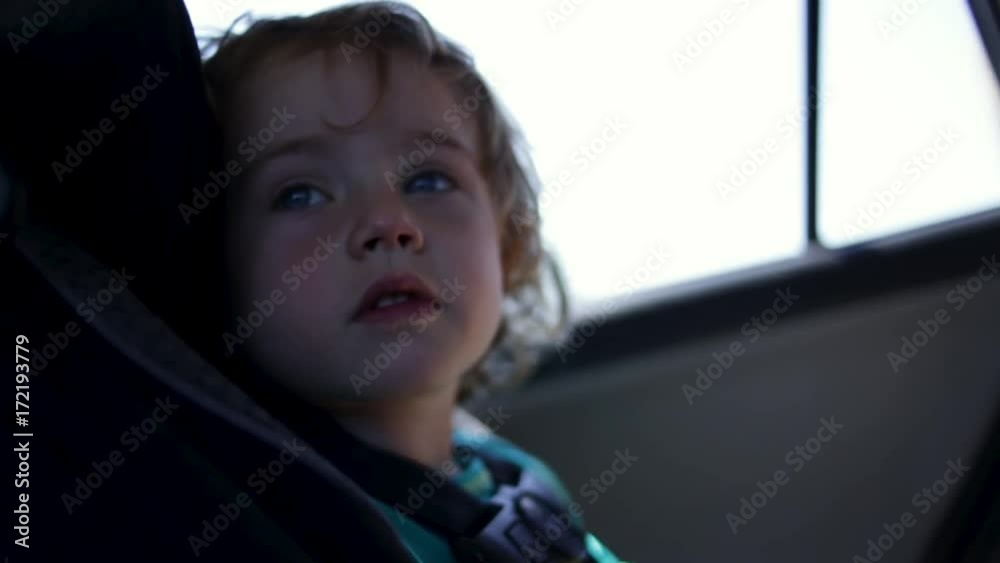 Cute 2 Year Old Little Boy Enjoys Car Ride, Looks Around, Slow Motion Closeup Cute 2 Year Old Little Boy Enjoys Car Ride, Looks Around, Slow Motion Closeup