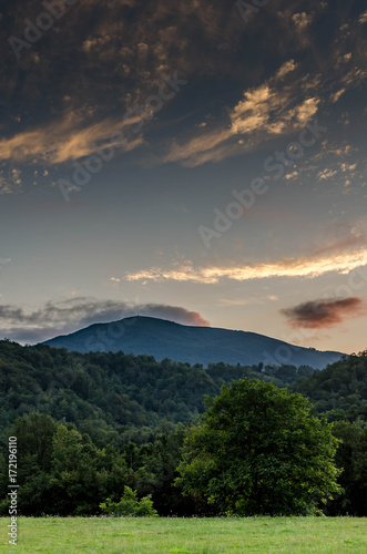 sunset in mountain landscape with cloudy sky
