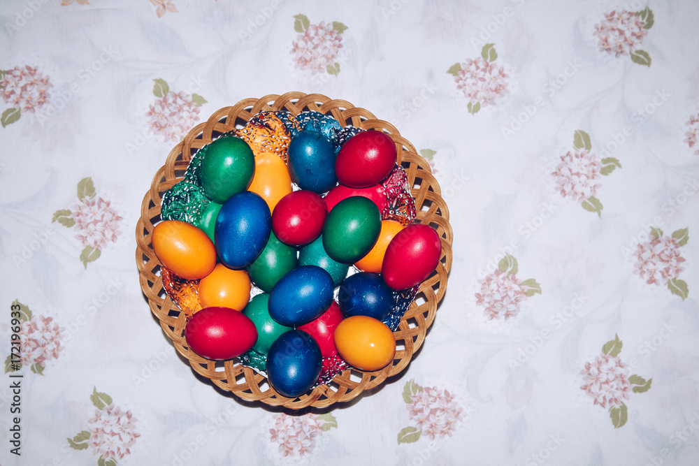 Fototapeta premium Colorful easter eggs in basket. Happy Easter, Christian religious holiday.