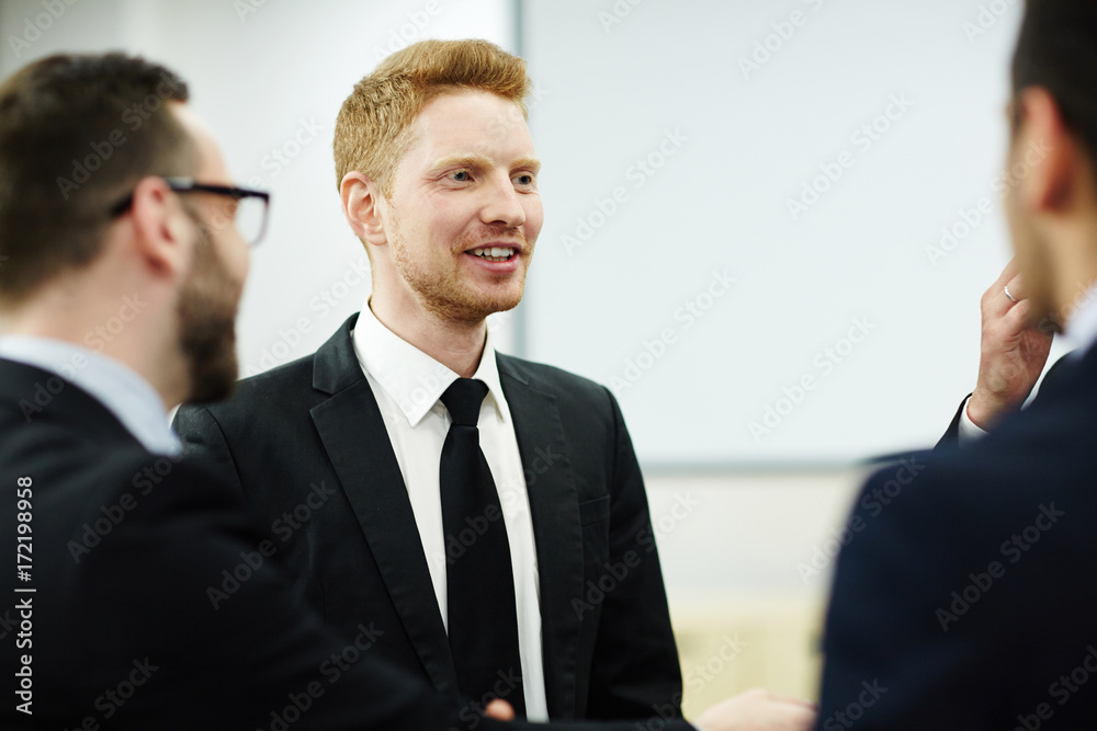 Young businessmen discussing new tendencies on the market Young businessmen discussing new tendencies on the market