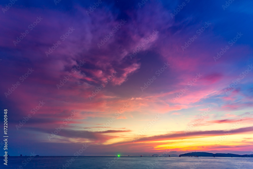Beautiful tropical sunset in Krabi, Thailand. Dramatic and picturesque evening scene. Ocean and colorful pink cloudy sky in the background. Nature landscape. Travel background. Bright purple toning