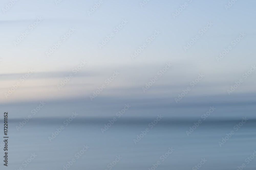 Abstract landscape image of vibrant blurred coastal sunrise