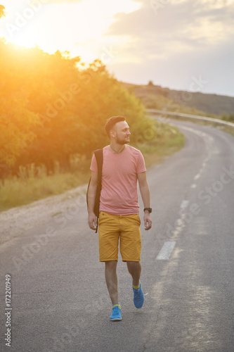 Young man smiling and enjoying sunny summer day