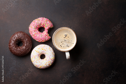 Coffee cup and colorful donuts