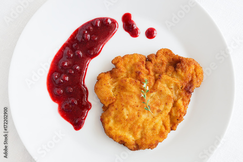 turkey schnitzel with wild berries sauce decorated with thyme