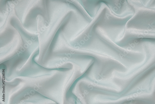 light turquoise satin material, blue sateen fabric,  silk textile, beautiful creative background