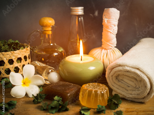 Spa massage items in candlelight,aroma oil and herbal ball.