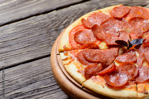 Homemade pepperoni pizza on a wooden Board