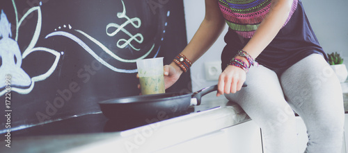 Fitness girl cooking healthy food in the kitchen. Woman. Kitchen. Cooking © lenets_tan
