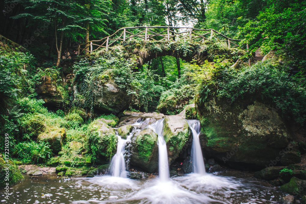 Stone bridge over a waterfall. Stone bridge over a waterfall.