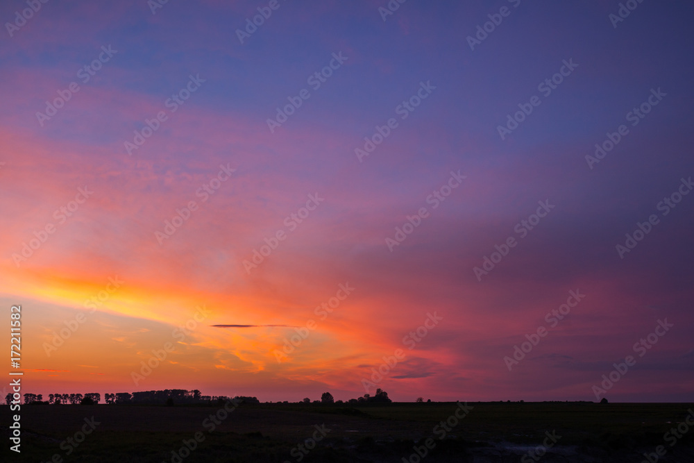 Natural Sunset Sunrise Over Field Or Meadow. Bright Dramatic Sky And Dark Ground. Countryside Landscape Under Scenic Colorful Sky At Sunset Dawn Sunrise. Sun Over Skyline, Horizon. Warm Colours. Natural Sunset Sunrise Over Field Or Meadow. Bright Dramatic Sky And Dark Ground. Countryside Landscape Under Scenic Colorful Sky At Sunset Dawn Sunrise. Sun Over Skyline, Horizon. Warm Colours.