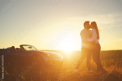Happiness couple stay near the new sport car