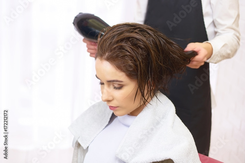 Woman at the hairdresser. Girl with wet hair.