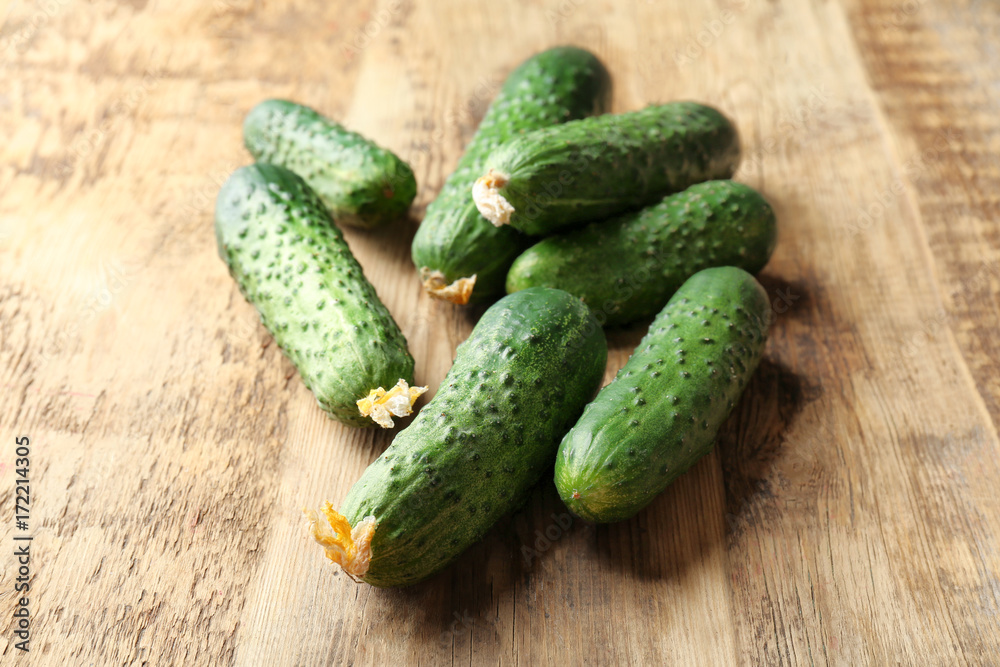 Many green fresh cucumbers on wooden table Many green fresh cucumbers on wooden table
