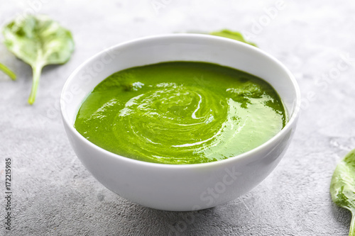 Bowl with tasty spinach soup on table