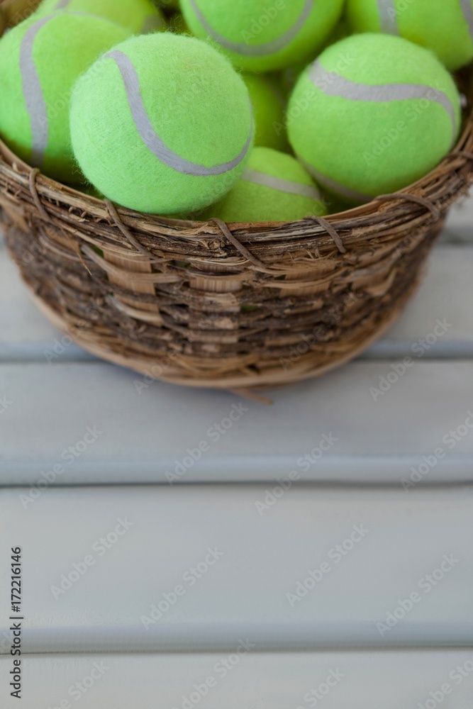 High angle view of fluorescent yellow tennis balls in wicker