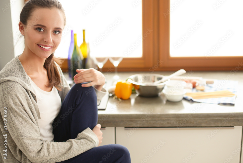 Woman in the kitchen. Cooking at kitchen.