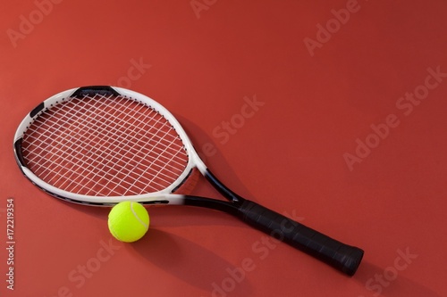 High angle view of tennis racket and fluorescent yellow ball © WavebreakMediaMicro