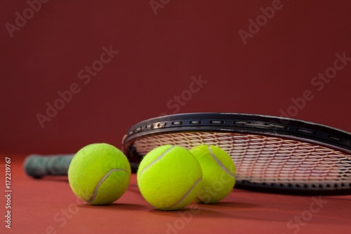Close up of tennis racket on balls © WavebreakMediaMicro