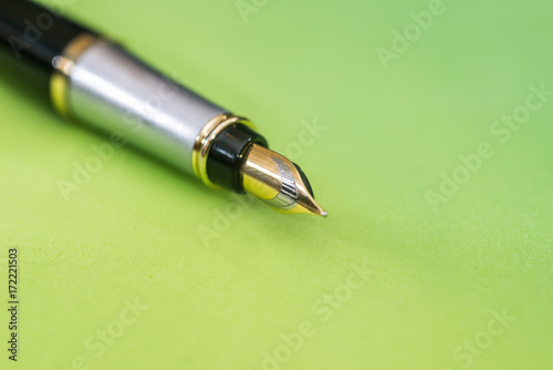 pen isolated on green background. Office equipment for paperwork.