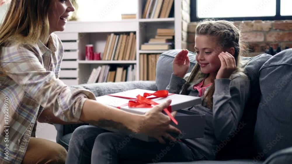 Girl receiving puppy as a present