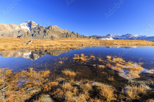 Peaks of Mount Disgrazia and Bernina Group reflected in the lake Val Torreggio Malenco Valley Valtellina Lombardy Italy Europe photo