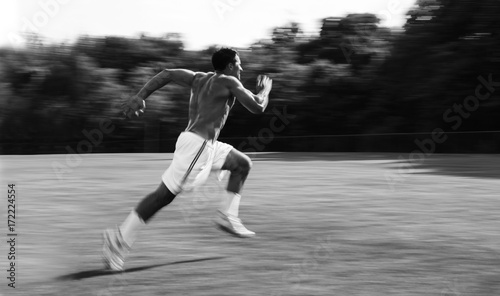 Athletic man running and training for sports photo